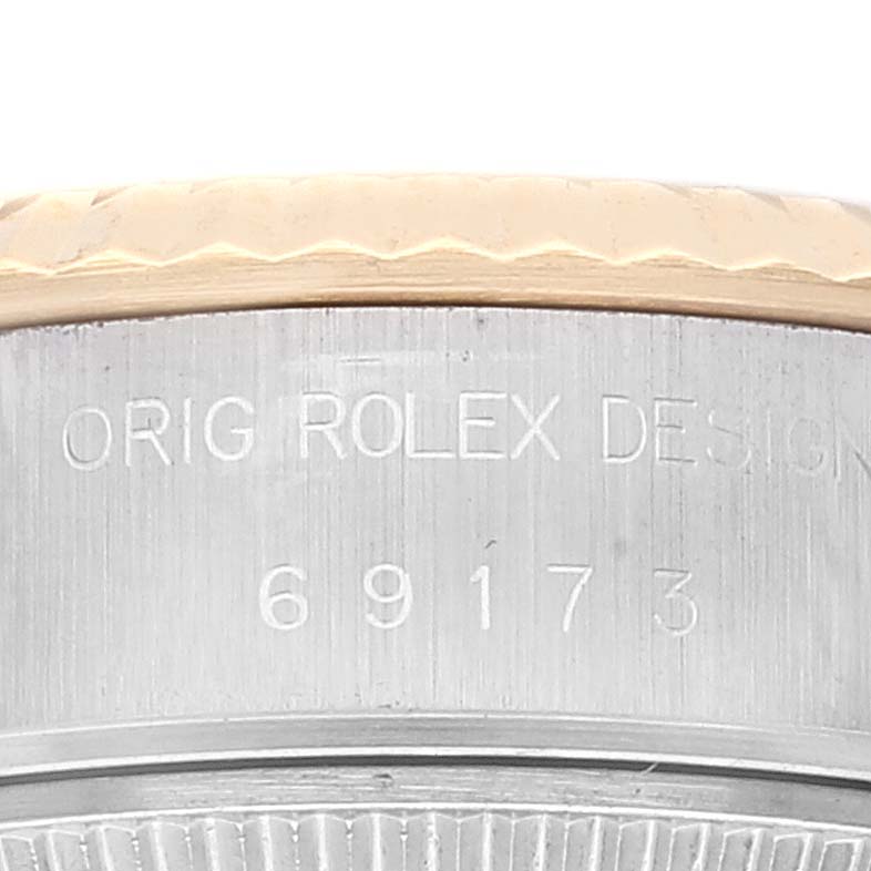 This image shows a close-up of the side engraving and part of the bezel of a Rolex Datejust 69173 Women's Steel and Gold (two tone) Champagne Dial 69173 Women's Steel and Gold (two tone) Champagne Dial watch.