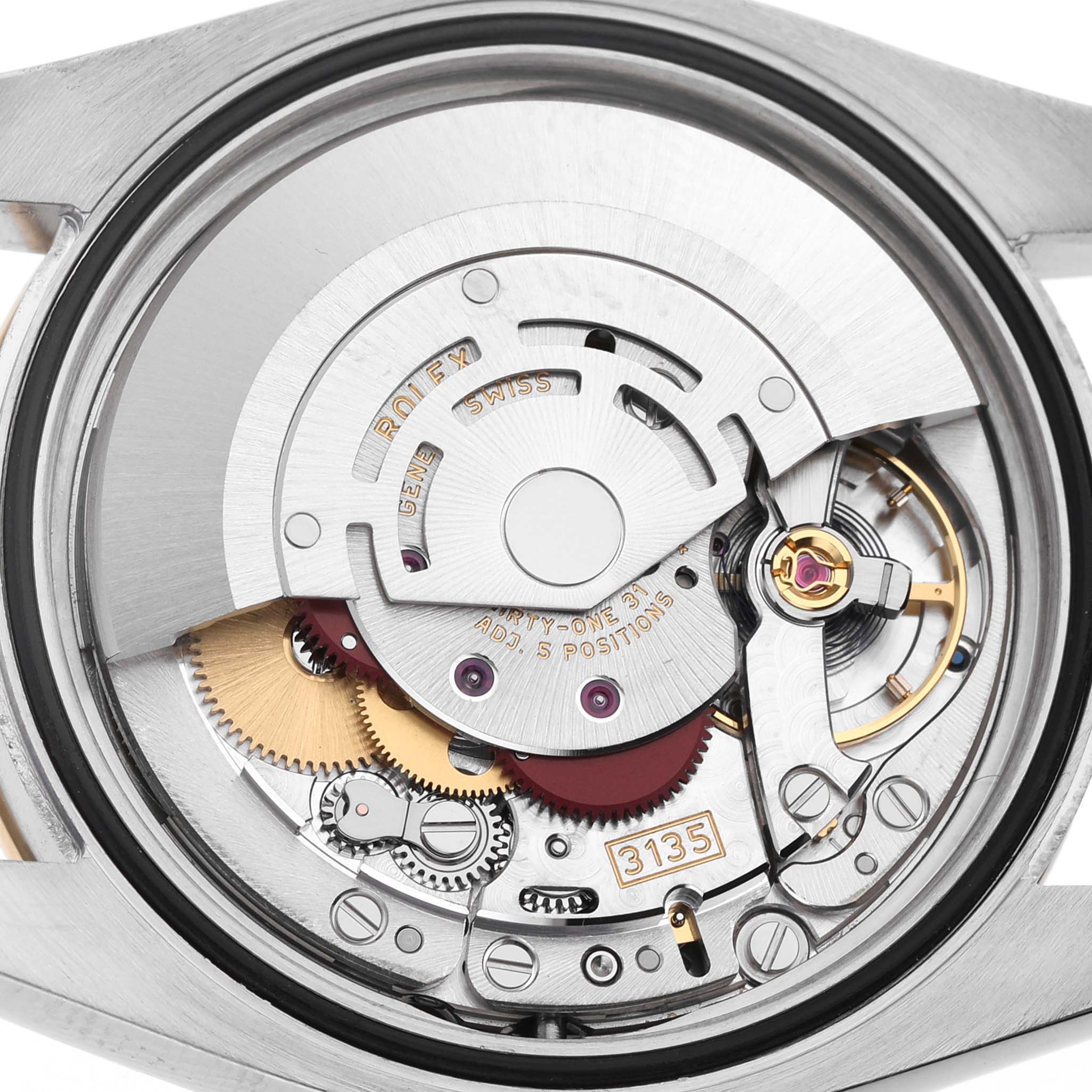 The image shows a close-up view of the movement inside a Rolex Datejust 116243 Men's Steel and Gold (two tone) Silver Dial, highlighting its intricate mechanical components.