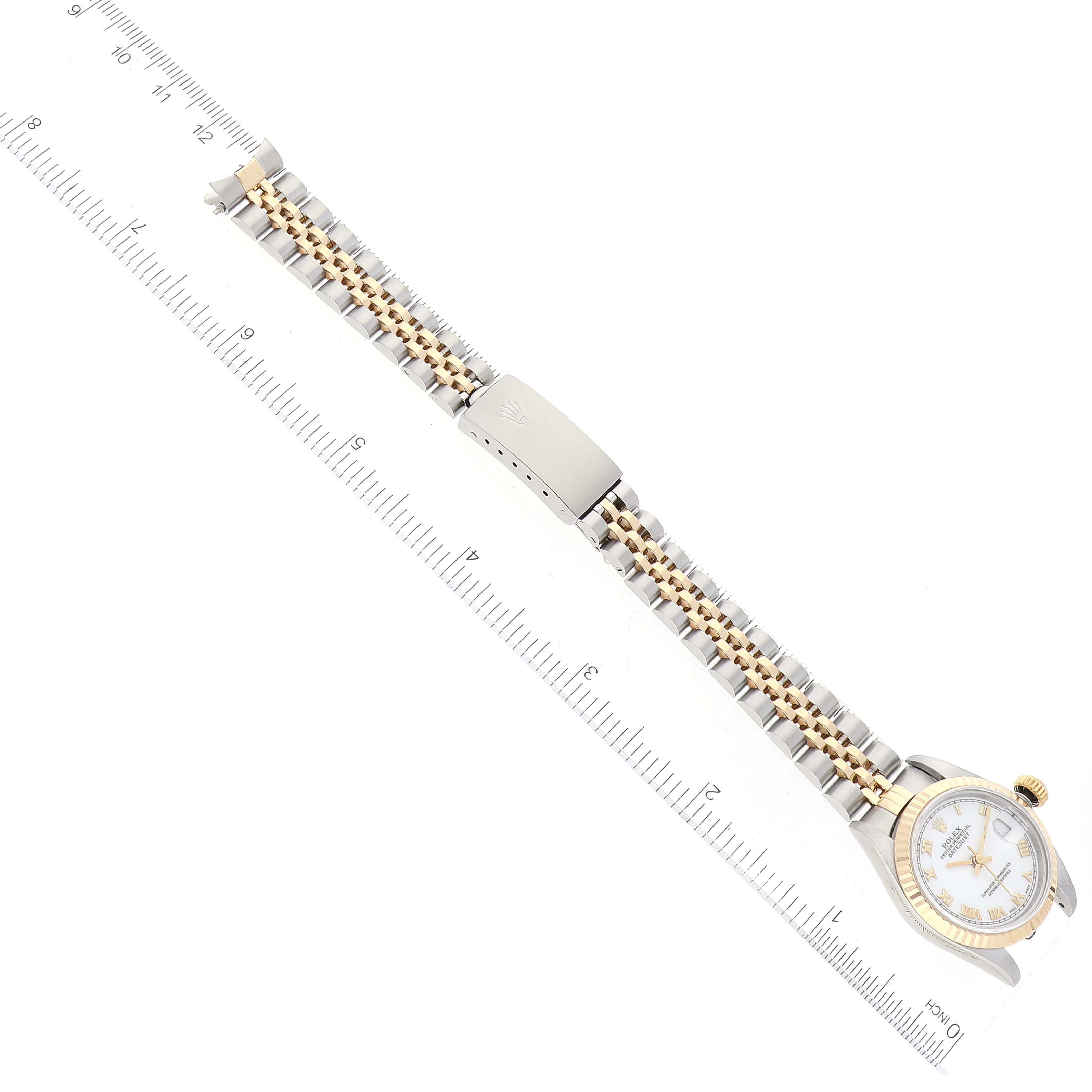 The image shows a top-down view of a Rolex Datejust 69173 Women's Steel and Gold (two tone) White Dial 69173 Women's Steel and Gold (two tone) White Dial watch fully extended alongside a ruler.