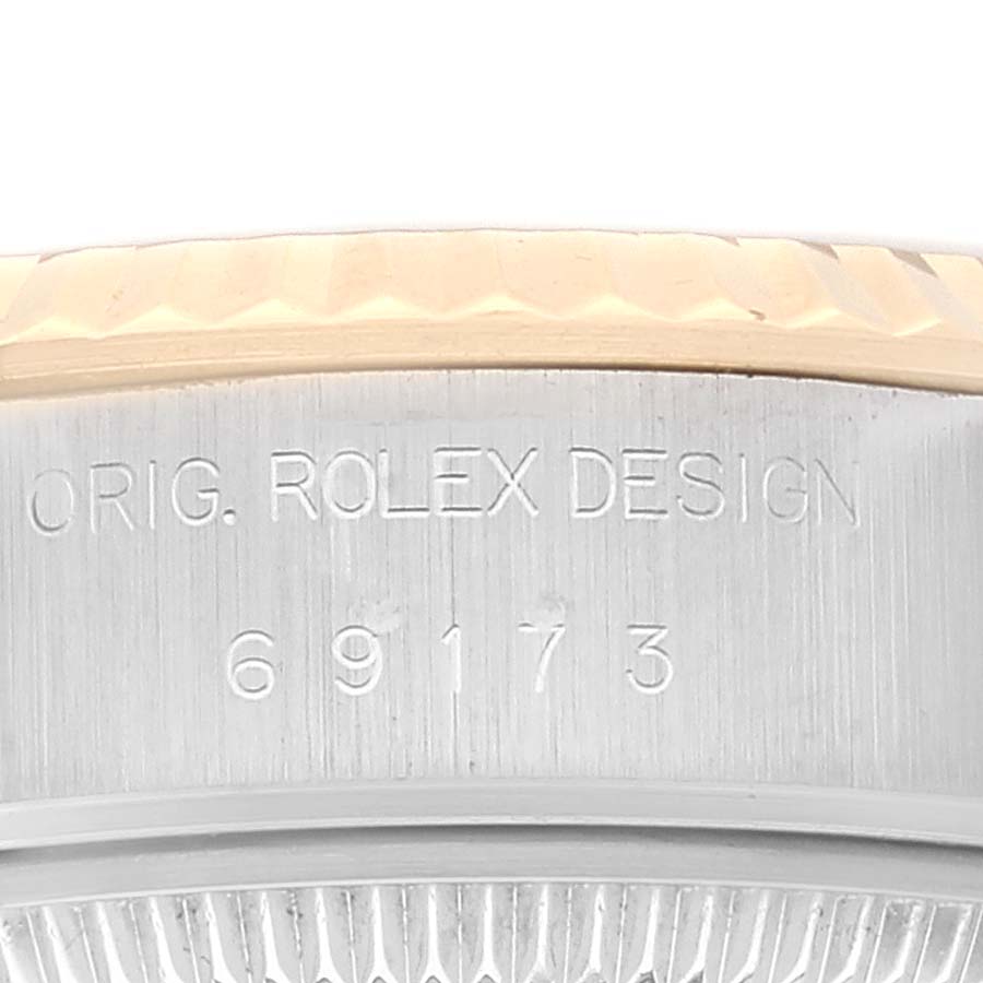 This image shows a close-up of the side view of a Rolex Datejust 69173 Women's Steel and Gold (two tone) White Dial 69173 Women's Steel and Gold (two tone) White Dial watch, focusing on its model number and "Orig. Rolex Design" engraving.