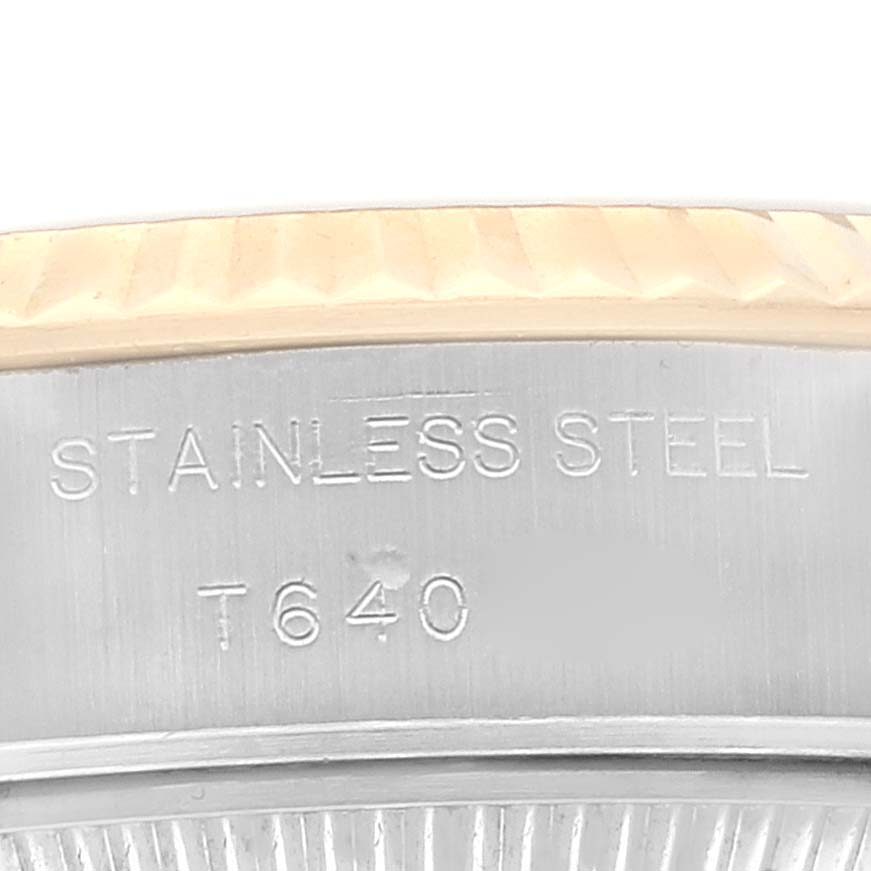 This close-up image shows the side of a Rolex Datejust 69173 Women's Steel and Gold (two tone) White Dial 69173 Women's Steel and Gold (two tone) White Dial watch with the stainless steel marking and part of the fluted bezel.