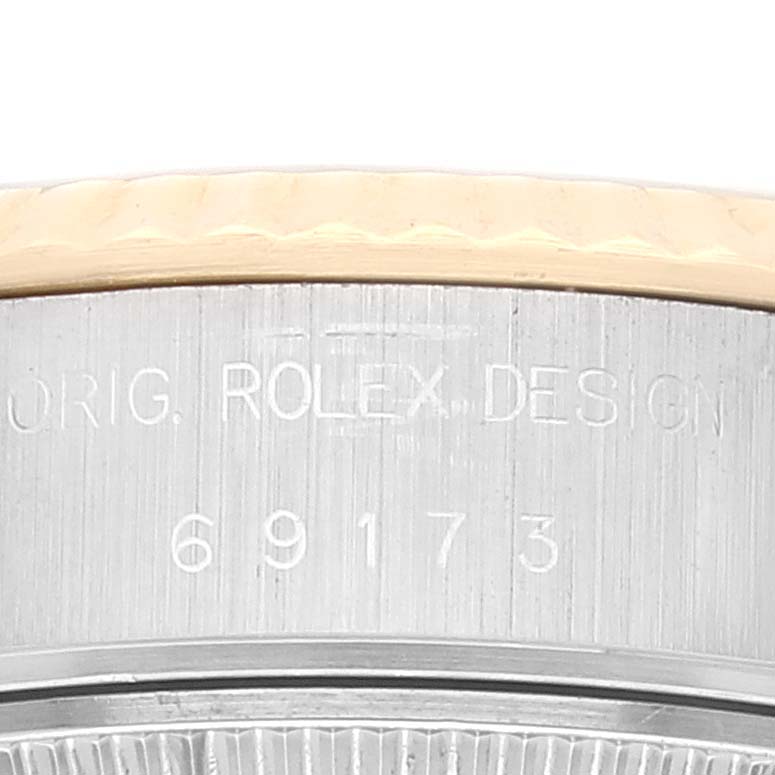 The image shows a close-up of the case side on a Rolex Datejust 69173 Women's Steel and Gold (two tone) White Dial 69173 Women's Steel and Gold (two tone) White Dial watch, highlighting the model number 69173 and "ROLEX DESIGN" engraving.