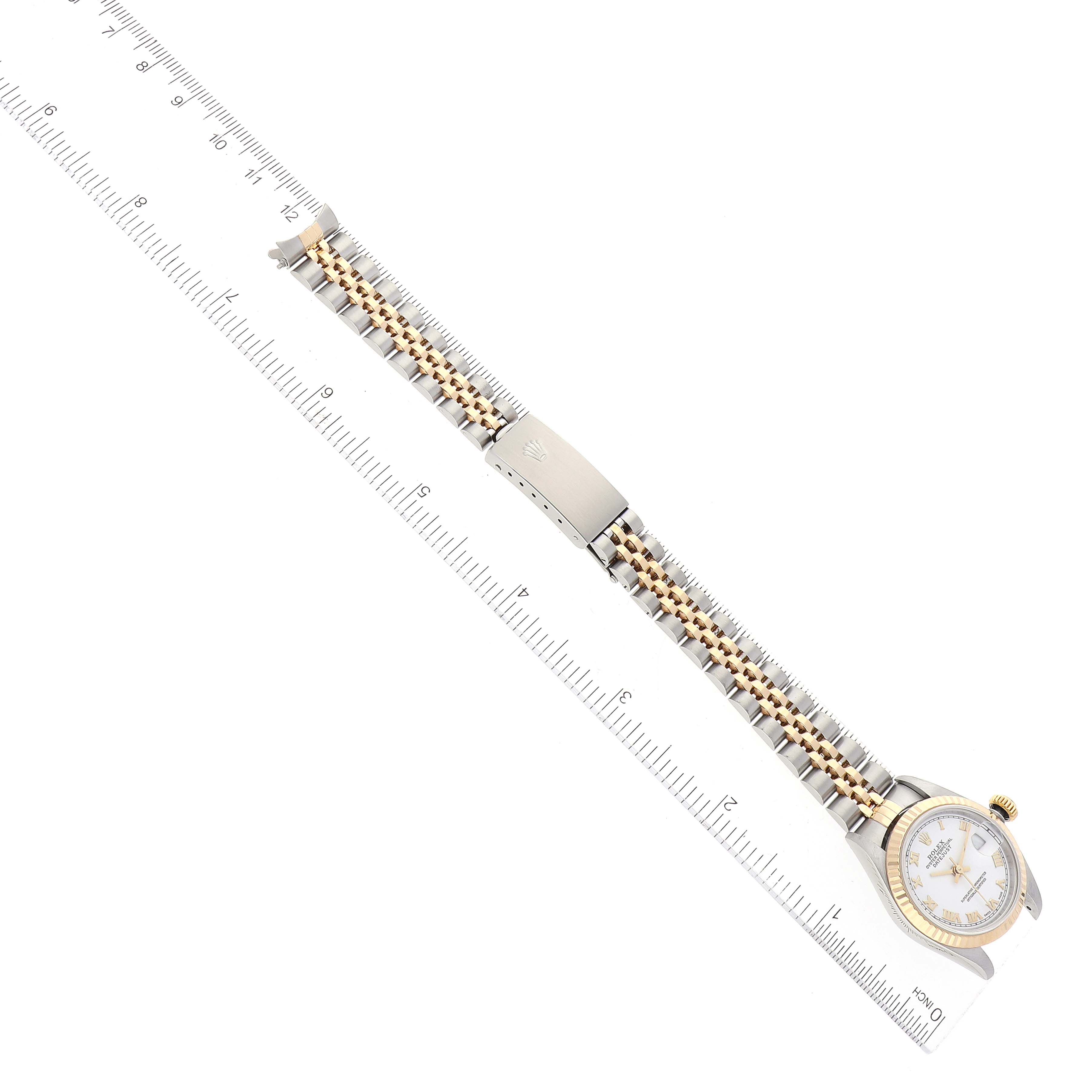 The image shows a Rolex Datejust 79173 Women's Steel and Gold (two tone) White Dial 79173 Women's Steel and Gold (two tone) White Dial watch laid flat next to a ruler, displaying the dial, bezel, bracelet, and clasp.