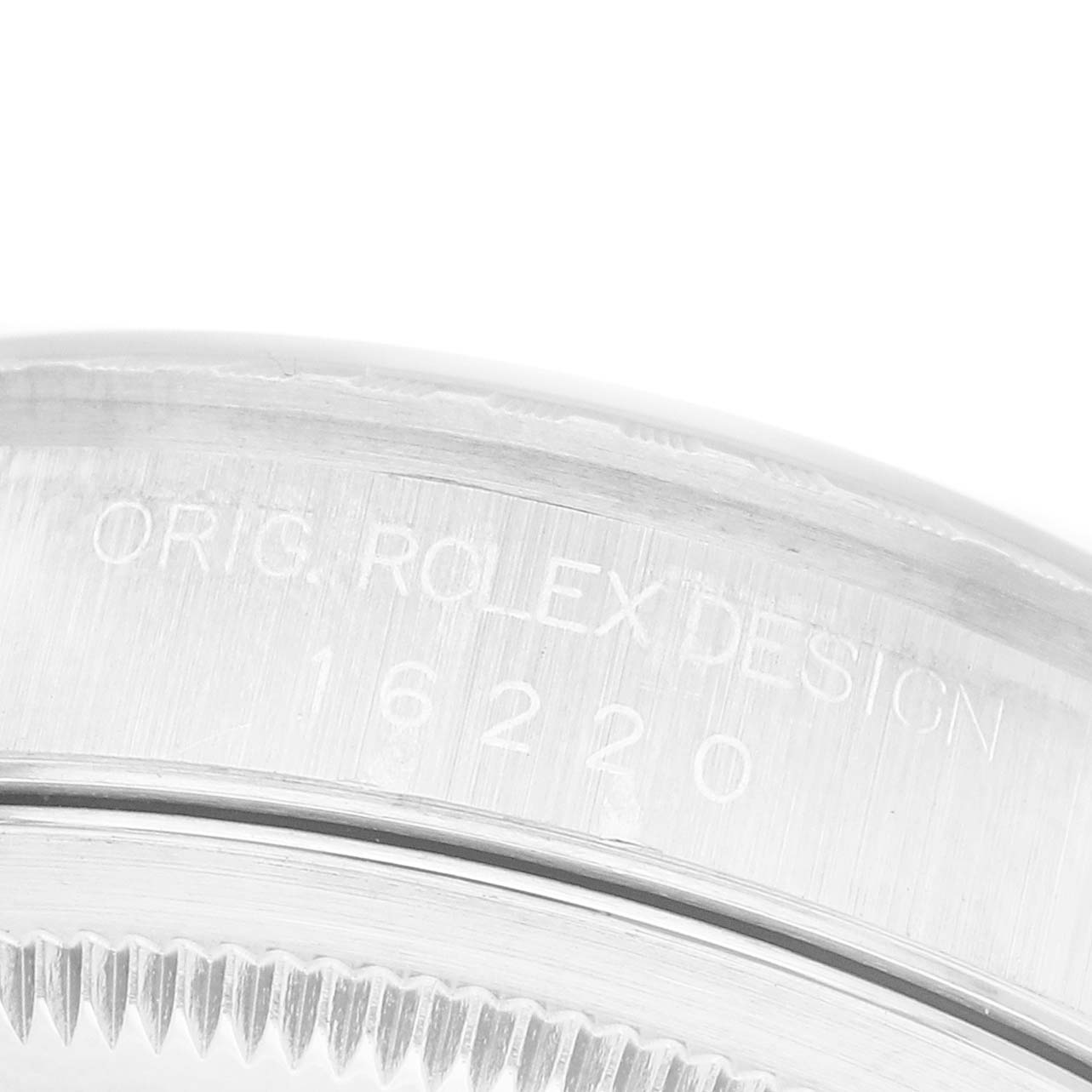 The image shows the side engraving on the bezel of a Rolex Datejust 16220 Men's Stainless Steel White Dial, displaying "ORIG ROLEX DESIGN" and the model number.