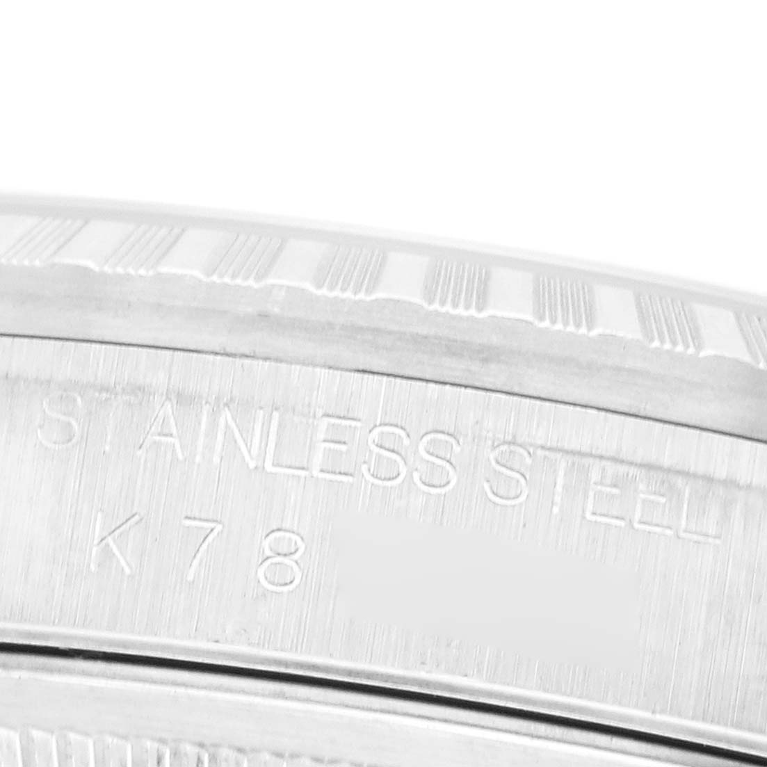 The image shows a close-up of the case back and stainless steel engraving on the Rolex Datejust 16220 Men's Stainless Steel White Dial.