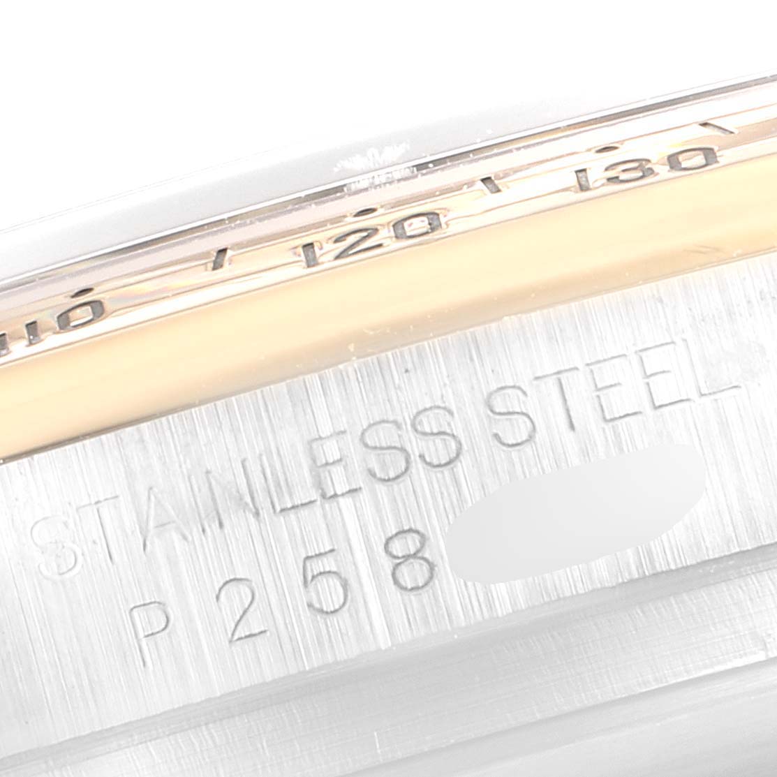 The image shows a close-up angle of the Rolex Daytona 116523 Men's Steel and Gold (two tone) Black Dial 116523 Men's Steel and Gold (two tone) Black Dial watch, highlighting the stainless steel material and partial engravings.