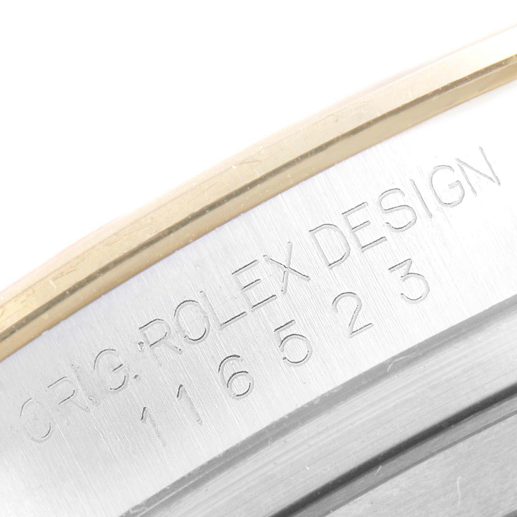 The image shows a close-up of the engraved serial number and "ROLEX DESIGN" text on the case of a Rolex Daytona 116523 Men's Steel and Gold (two tone) Black Dial 116523 Men's Steel and Gold (two tone) Black Dial watch.