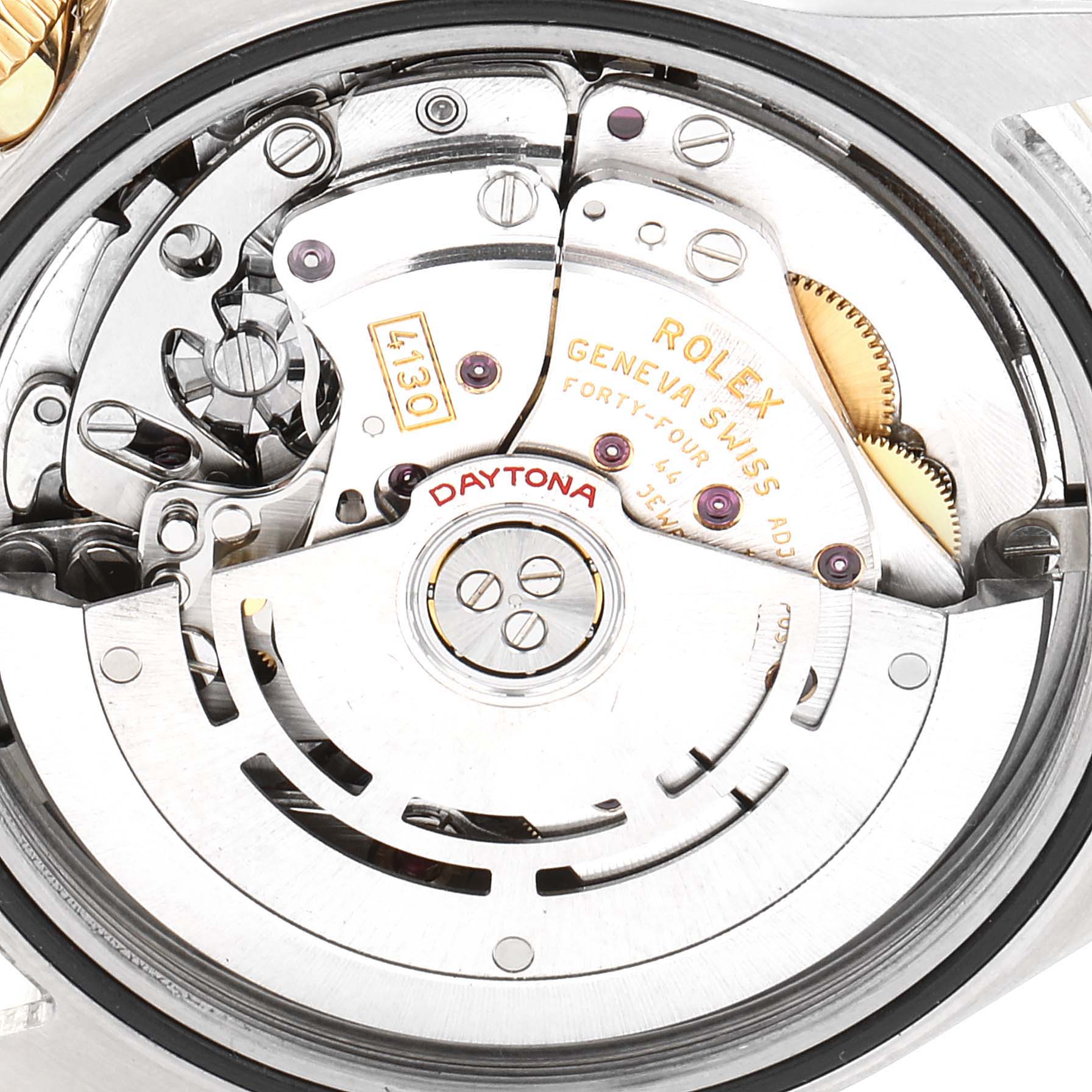 This is a close-up shot of the movement of a Rolex Daytona 116523 Men
s Steel and Gold (two tone) Blue Dial 116523 Men
s Steel and Gold (two tone) Blue Dial watch, showcasing internal mechanisms and engraving.
