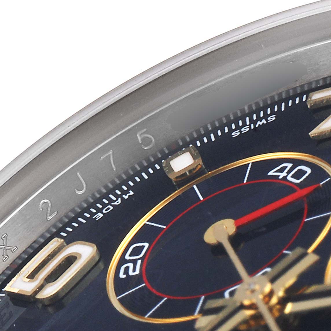 This close-up angle of the Rolex Daytona 116523 Men
s Steel and Gold (two tone) Blue Dial 116523 Men
s Steel and Gold (two tone) Blue Dial watch shows parts of the dial, bezel, and chronograph sub-dial.