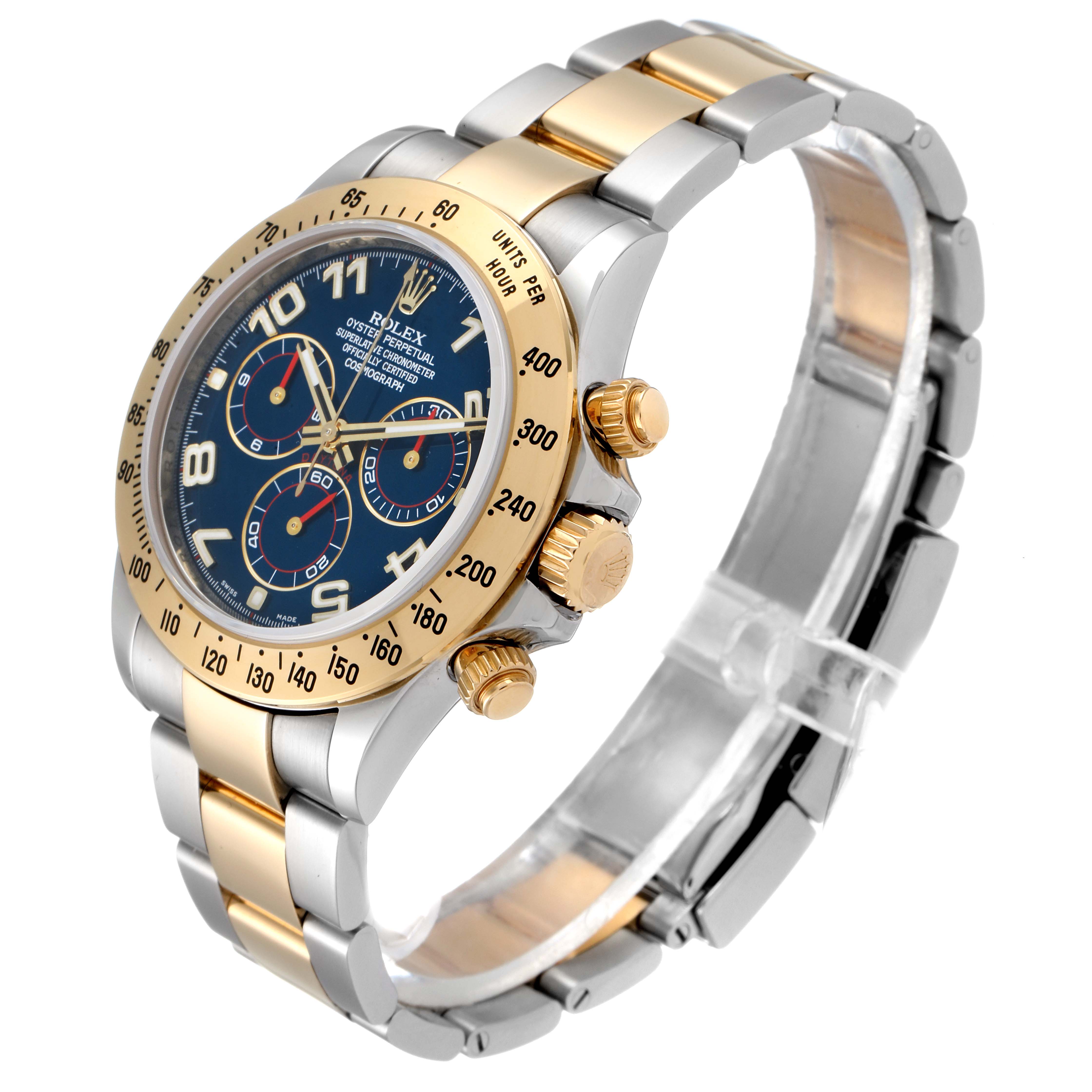 The image shows a Rolex Daytona 116523 Men
s Steel and Gold (two tone) Blue Dial 116523 Men
s Steel and Gold (two tone) Blue Dial watch at a three-quarter angle, highlighting its gold and silver band, blue dial, and chronograph pushers.