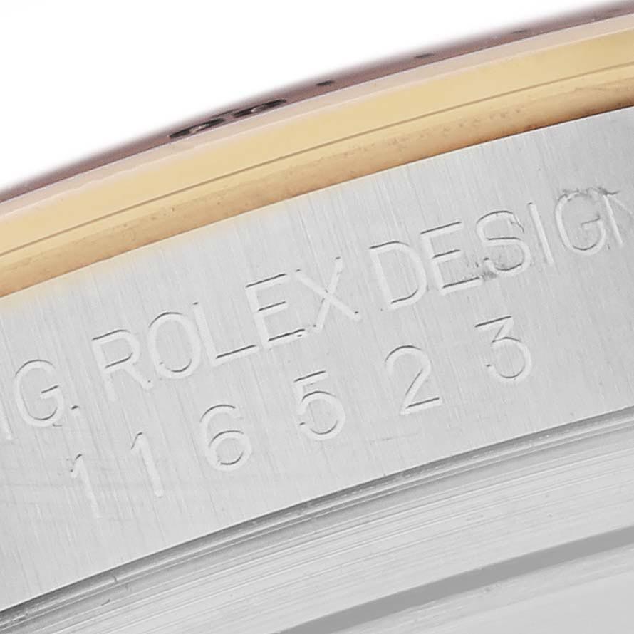 The image shows the engraved side of a Rolex Daytona 116523 Men's Steel and Gold (two tone) Grey Dial 116523 Men's Steel and Gold (two tone) Grey Dial, focusing on its model number on the metal case.