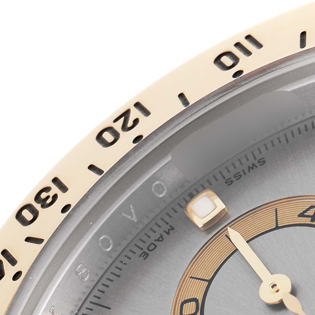 The image shows a close-up of the bezel and part of the dial of a Rolex Daytona 116523 Men's Steel and Gold (two tone) Grey Dial 116523 Men's Steel and Gold (two tone) Grey Dial watch, highlighting the tachymetric scale and hands.