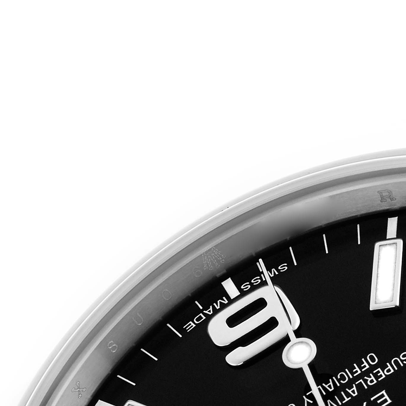 The image shows a close-up of the dial's edge for a Rolex Explorer 214270 Men's Stainless Steel Black Dial 214270 Men's Stainless Steel Black Dial, featuring part of the numeral "9" and various inscriptions.