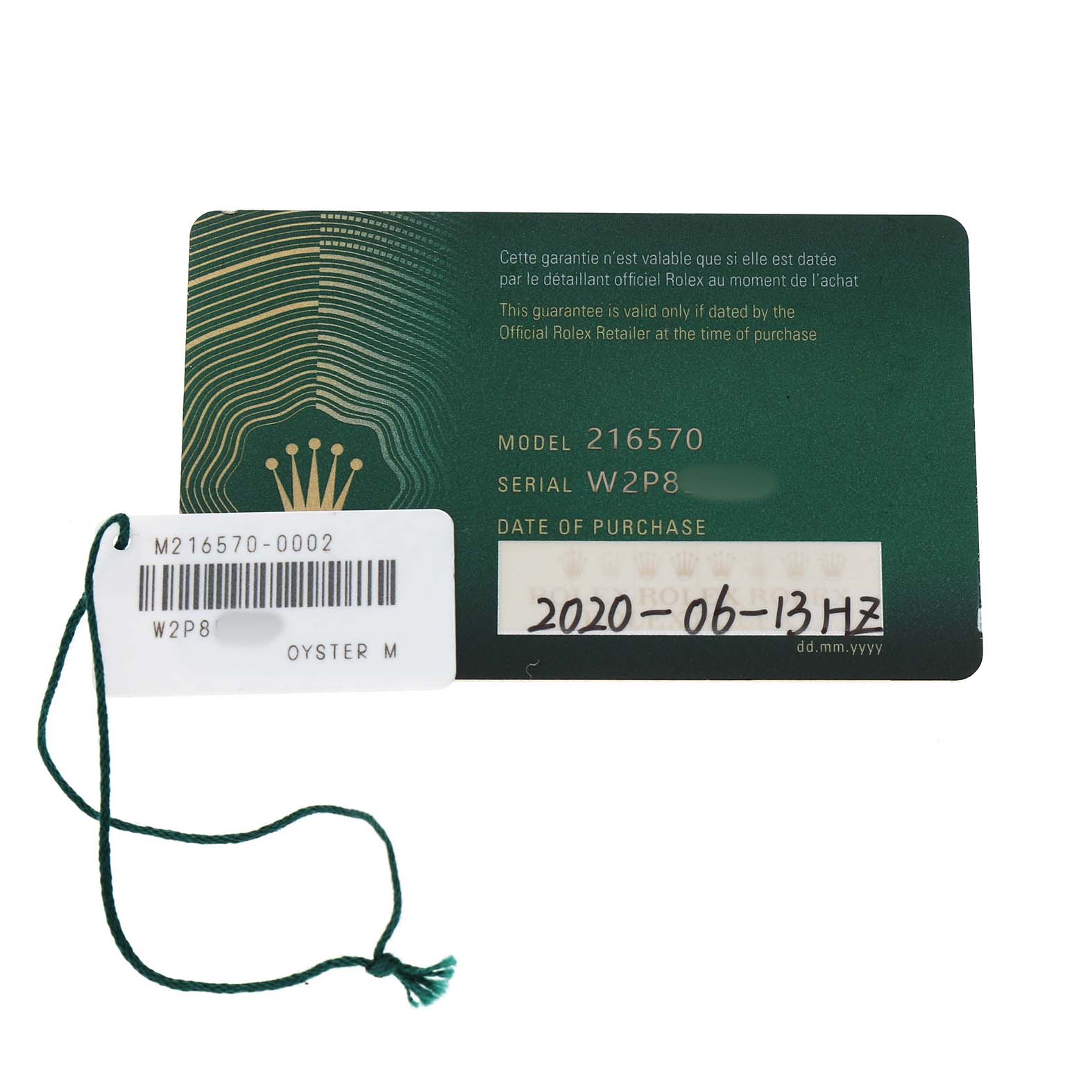 The image shows a warranty card and a tag for the Rolex Explorer 216570 Men's Stainless Steel Black Dial model, with model and serial numbers visible.