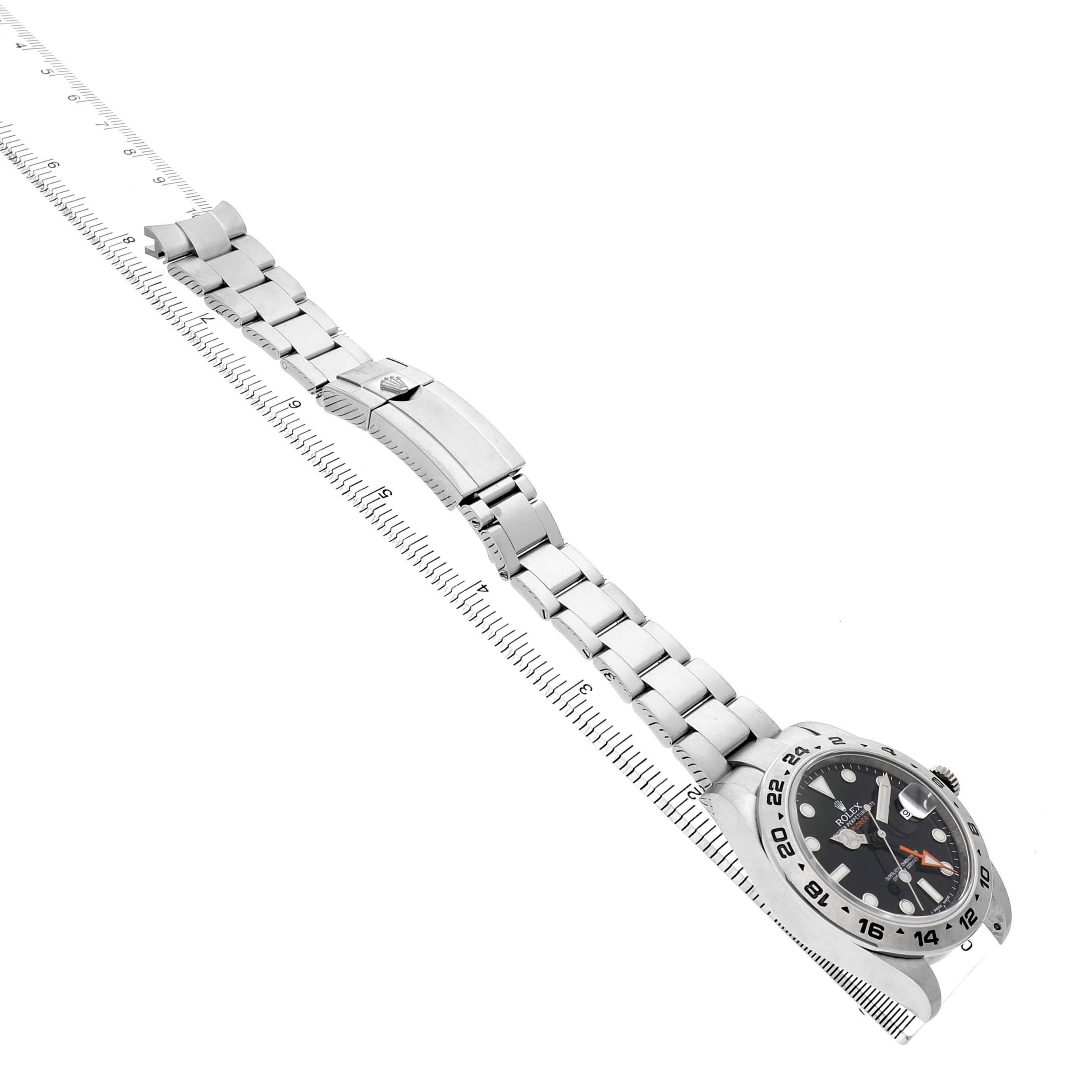 The Rolex Explorer 216570 Men's Stainless Steel Black Dial watch is shown at an angled view, displaying the watch face, bezel, crown, and full metal bracelet.