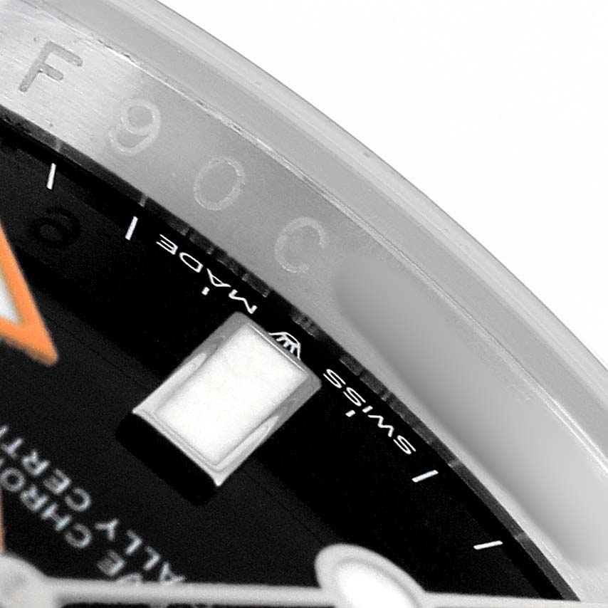 The image shows a close-up of the dial and part of the bezel of the Rolex Explorer 226570 Men's Stainless Steel Black Dial watch, focusing on the hour marker and "Swiss Made" text.