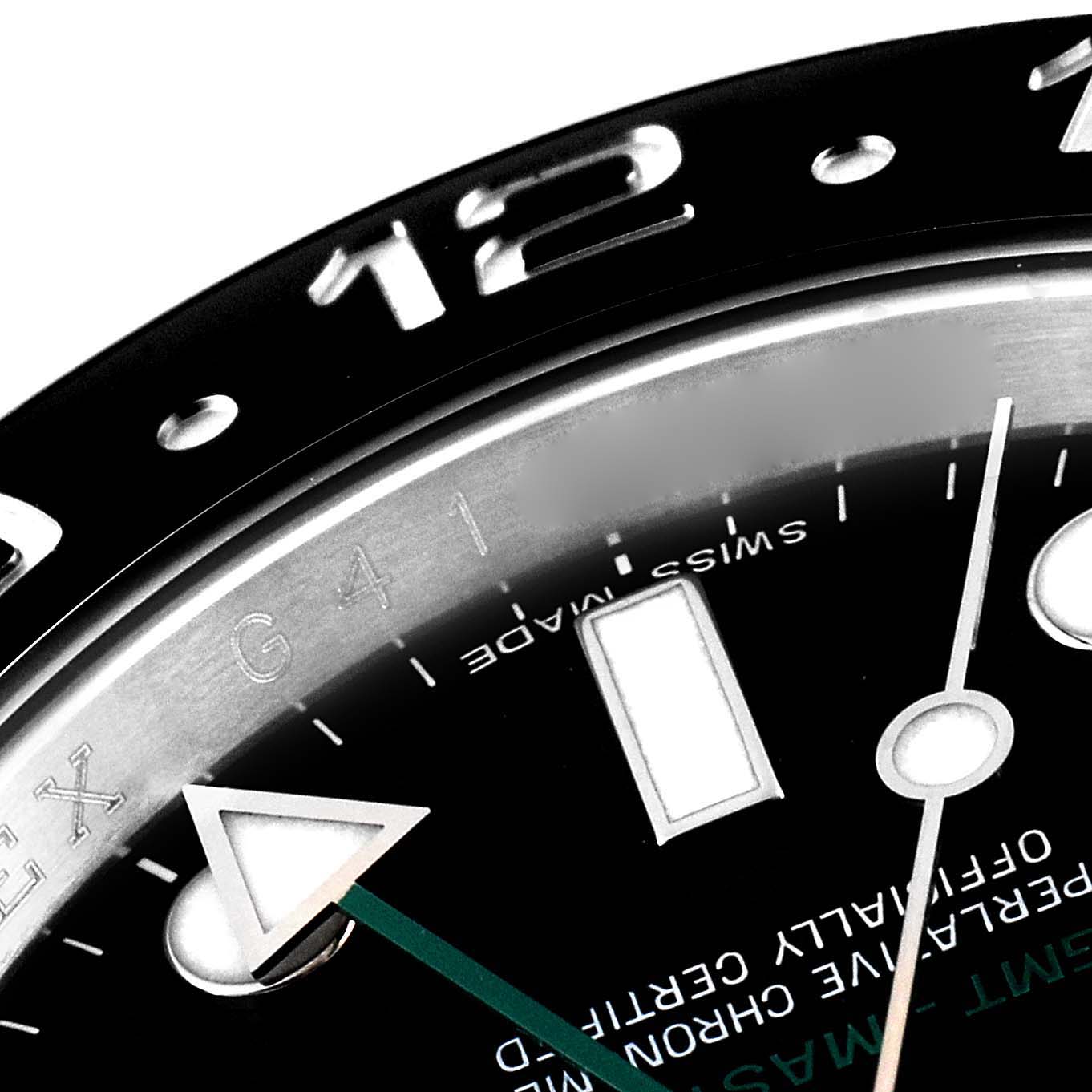 The image shows a close-up of the dial and bezel of a Rolex GMT-Master 116710 Men
s Stainless Steel Black Dial 116710 Men
s Stainless Steel Black Dial, highlighting the 12-hour marker and part of the hour hand.