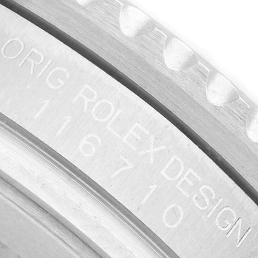 The image shows a close-up of the case side with engraved text on the Rolex GMT-Master 116710 Men's Stainless Steel Black Dial.