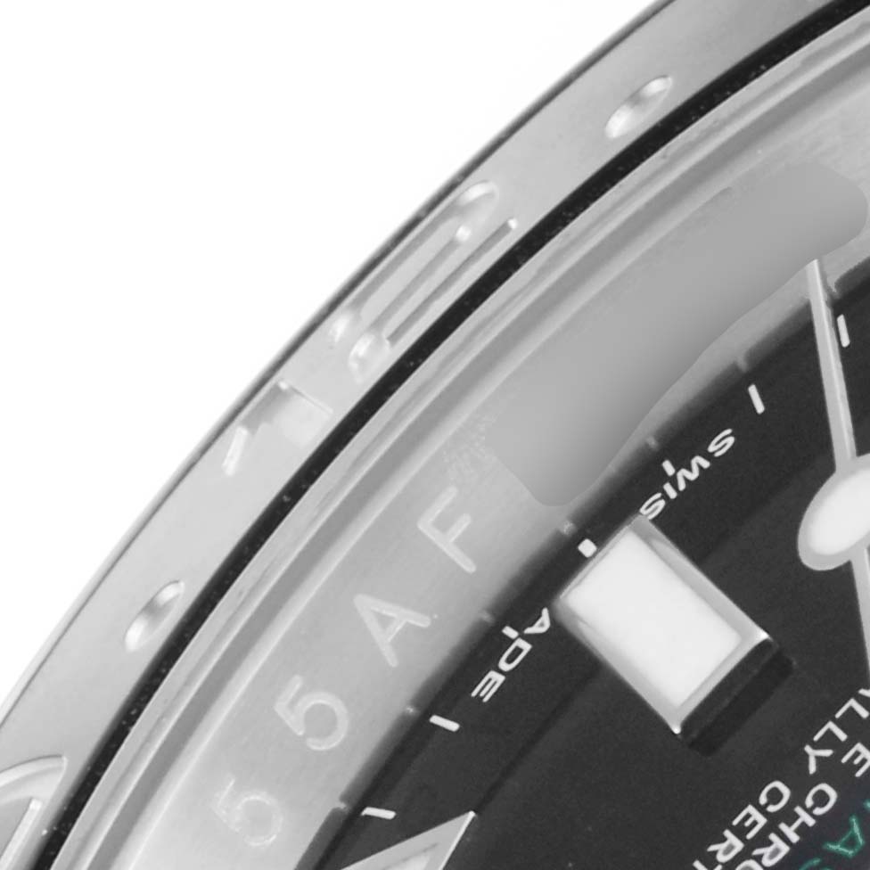 This close-up image of a Rolex GMT-Master 116710 Men's Stainless Steel Black Dial 116710 Men's Stainless Steel Black Dial watch shows part of the bezel and dial with the 24-hour markings.