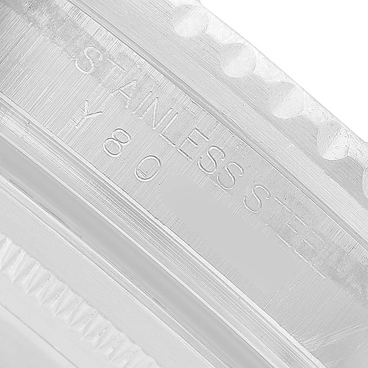The image shows a close-up of the bezel and edge of the case back of a Rolex GMT-Master 16710 Men's Stainless Steel Black Dial, highlighting details and markings.