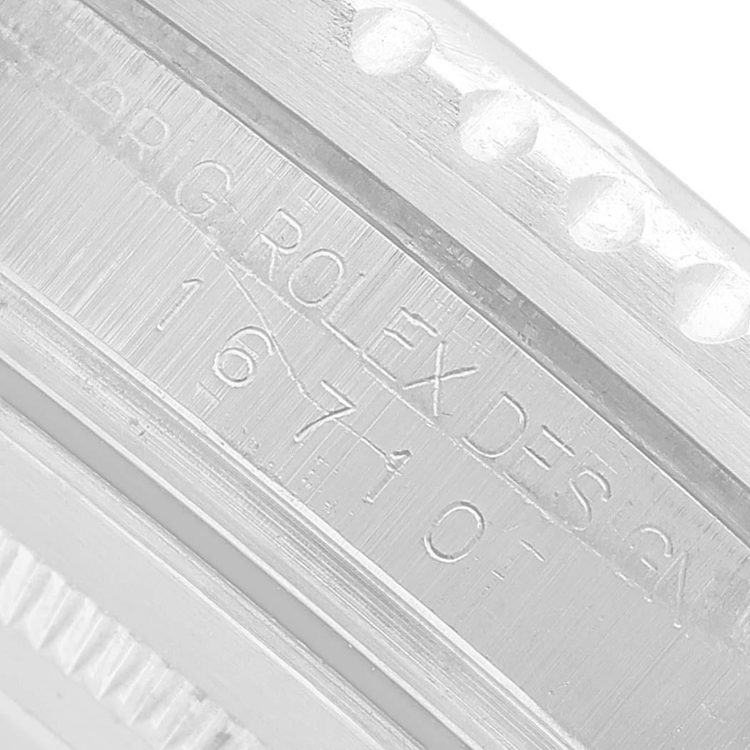 The image shows a close-up of the Rolex GMT-Master 16710 Men's Stainless Steel Black Dial's inner bezel with engraved model details.