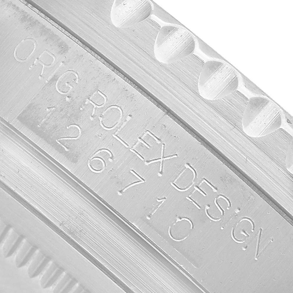 The image shows a close-up of the case engraving, including the model number, on the Rolex GMT-Master 126710 Men's Stainless Steel Black Dial.