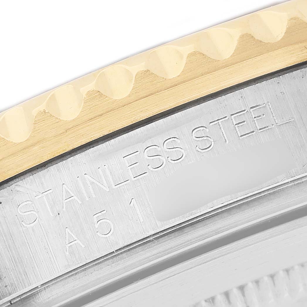 The image shows a close-up of the Rolex GMT-Master 16713LN Men's Steel and Gold (two tone) Black Dial watch's case back edge, highlighting "STAINLESS STEEL" engraving and the bezel.