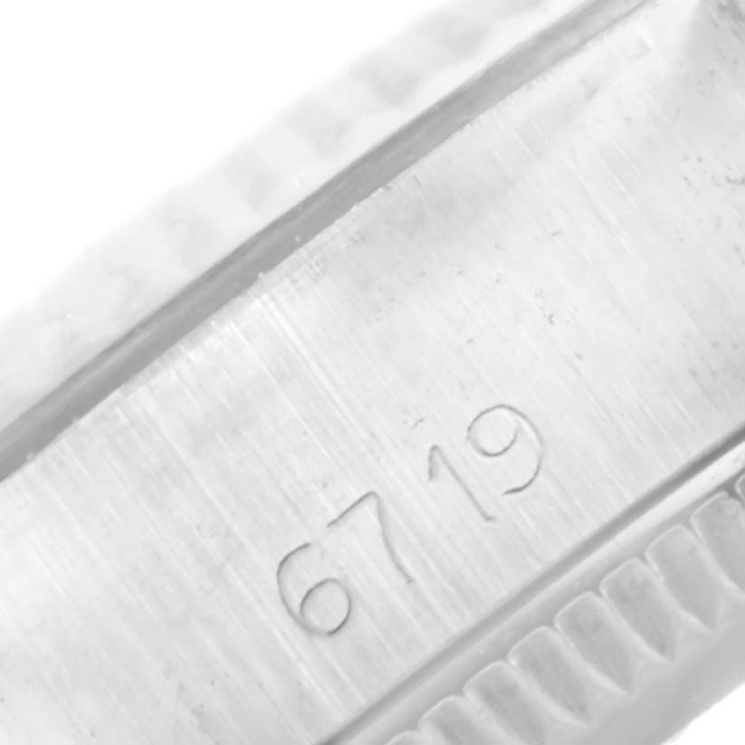 This close-up shows part of the case of the Rolex Oyster Perpetual 6719 Women's Stainless Steel Silver Dial 6719 Women's Stainless Steel Silver Dial watch, highlighting a "6719" engraving.