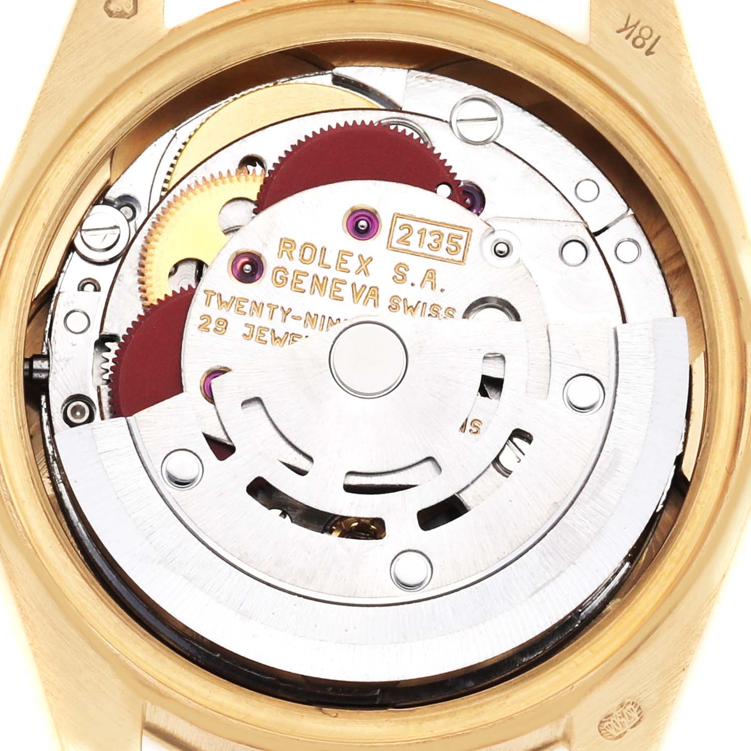 The image shows the movement of a Rolex President 69178 Women's Yellow Gold Champagne Dial 69178 Women's Yellow Gold Champagne Dial model at the back, revealing gears and components.
