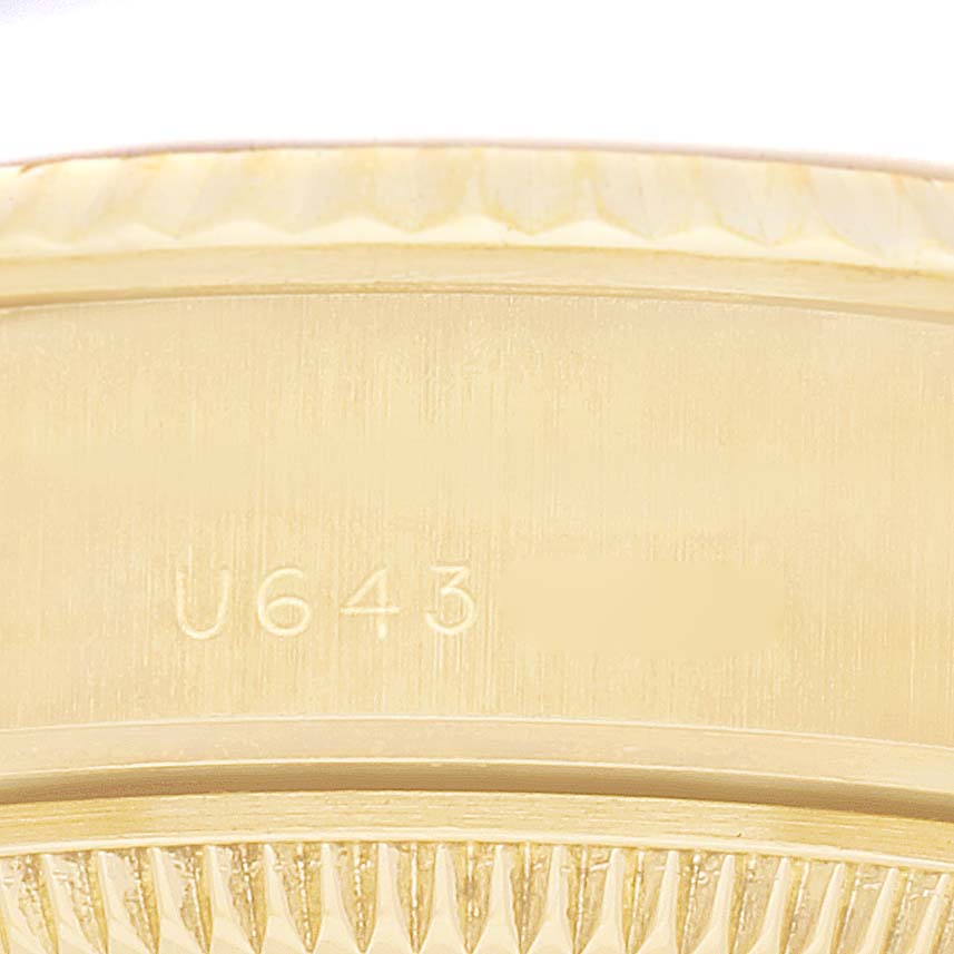 The image shows a close-up of the side of a Rolex President 69178 Women's Yellow Gold Champagne Dial 69178 Women's Yellow Gold Champagne Dial watch, highlighting its serial number engraving.