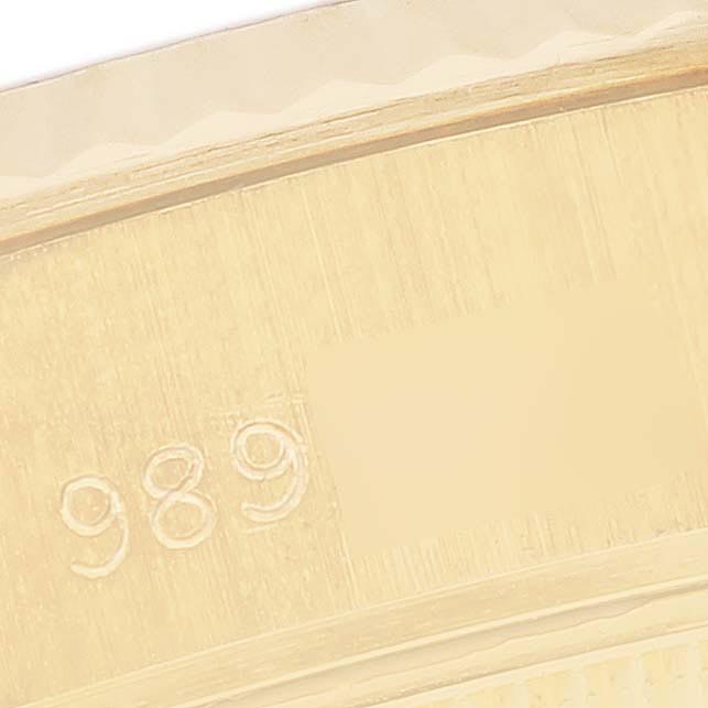 The image shows a close-up of the engraved serial number on the Rolex President 69178 Women's Yellow Gold Champagne Dial 69178 Women's Yellow Gold Champagne Dial model's case back.
