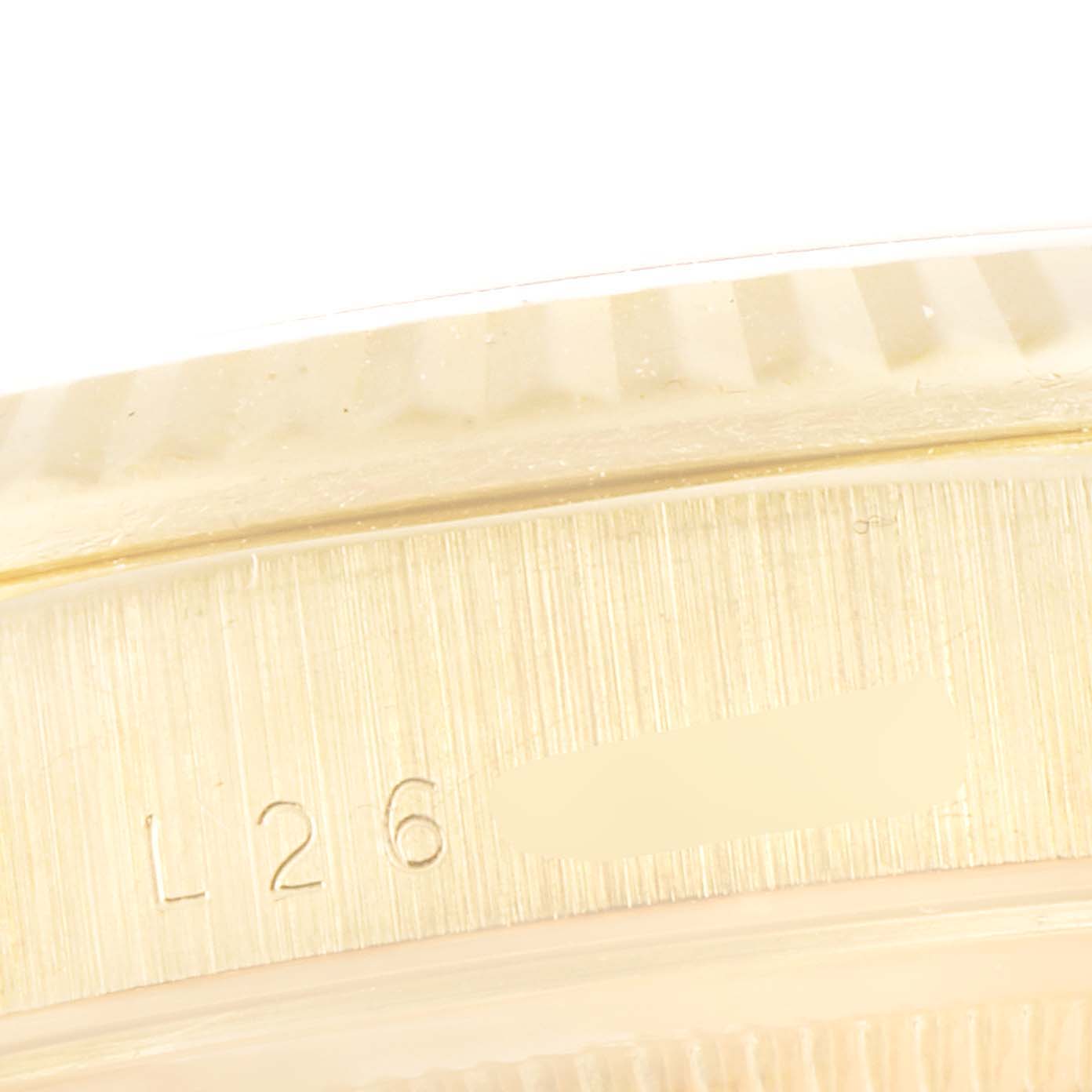 This image shows a close-up of the side view of the case of a Rolex President 18238 Men
s Yellow Gold Black Dial 18238 Men
s Yellow Gold Black Dial watch, highlighting its engraving and textured details.