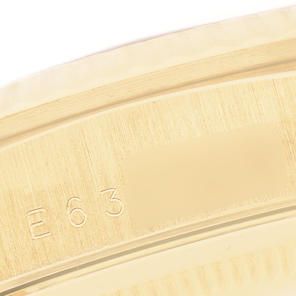 The image shows a close-up of the engraved serial number on a Rolex President 18238 Men
s Yellow Gold Champagne Dial 18238 Men
s Yellow Gold Champagne Dial model watch.