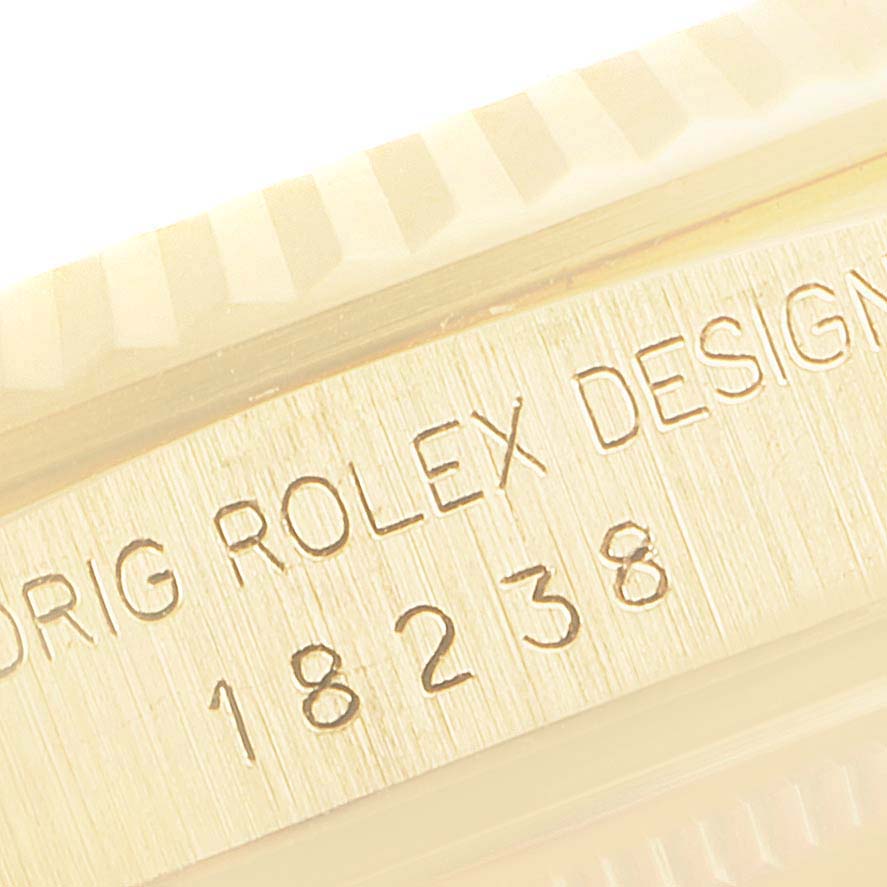 The image shows a close-up of the engraved side of a Rolex President 18238 Men's Yellow Gold Champagne Dial 18238 Men's Yellow Gold Champagne Dial model, including the text "ORIG ROLEX DESIGN" and the model number 18238.
