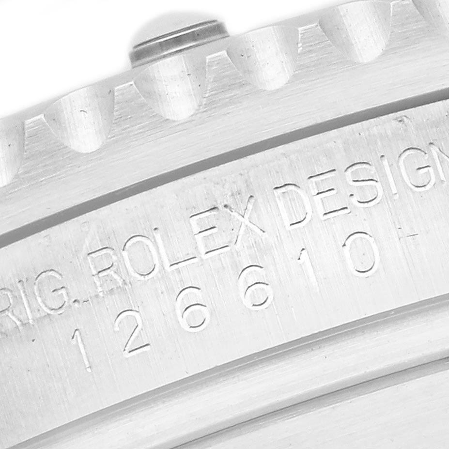 The image shows a close-up of the Rolex Submariner 126610LN Men's Stainless Steel Black Dial 126610LN Men's Stainless Steel Black Dial's bezel and engraved serial number on the case.