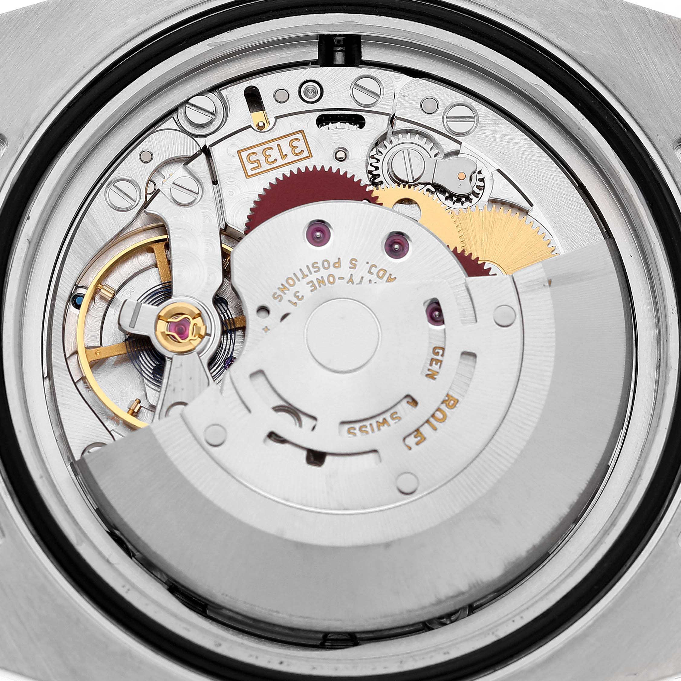 This image shows the movement mechanism of a Rolex Submariner 116610 Men's Stainless Steel Black Dial watch, featuring gears and the rotor from a top-down angle.