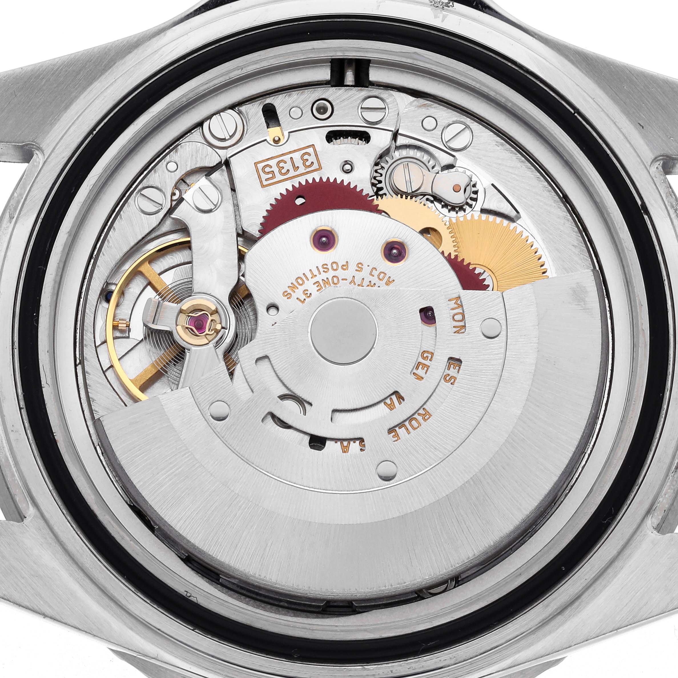 The image shows the movement of a Rolex Submariner 16610 Men's Stainless Steel Black Dial 16610 Men's Stainless Steel Black Dial watch from the back, highlighting gears and components.