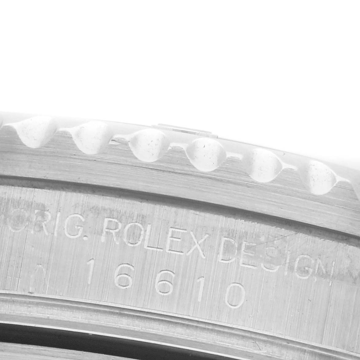 The image shows a close-up of the bezel edge and engraved case side of a Rolex Submariner 16610 Men's Stainless Steel Black Dial 16610 Men's Stainless Steel Black Dial watch.