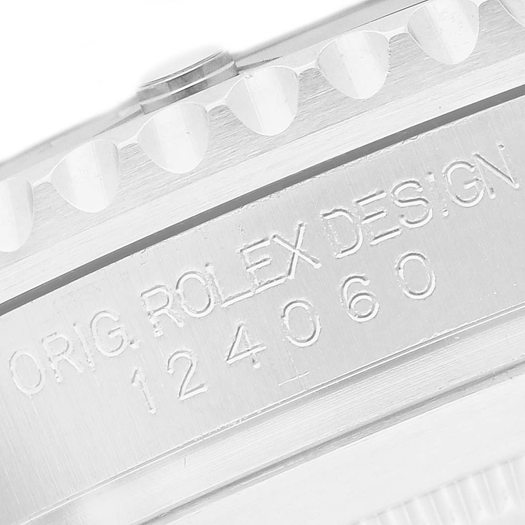 The image shows the side of the case of a Rolex Submariner 124060 Men's Stainless Steel Black Dial, highlighting the engraved model and design numbers.