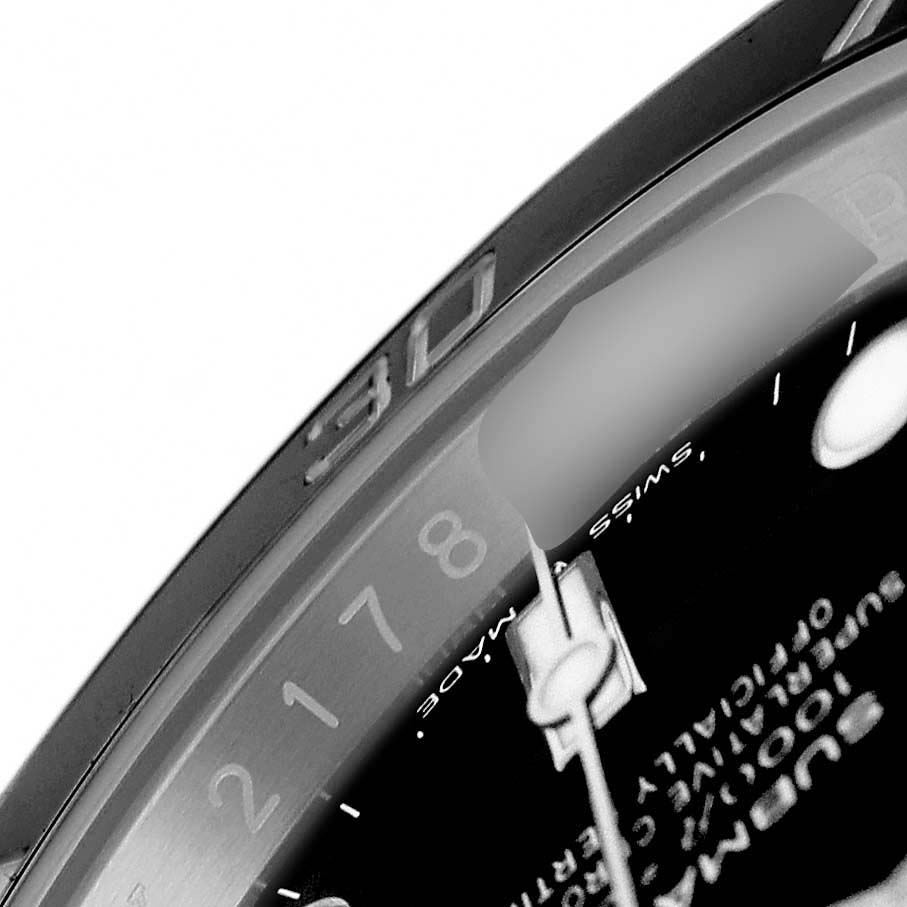 The image shows a partial view of the dial and bezel of a Rolex Submariner 124060 Men's Stainless Steel Black Dial watch from a close-up angle.