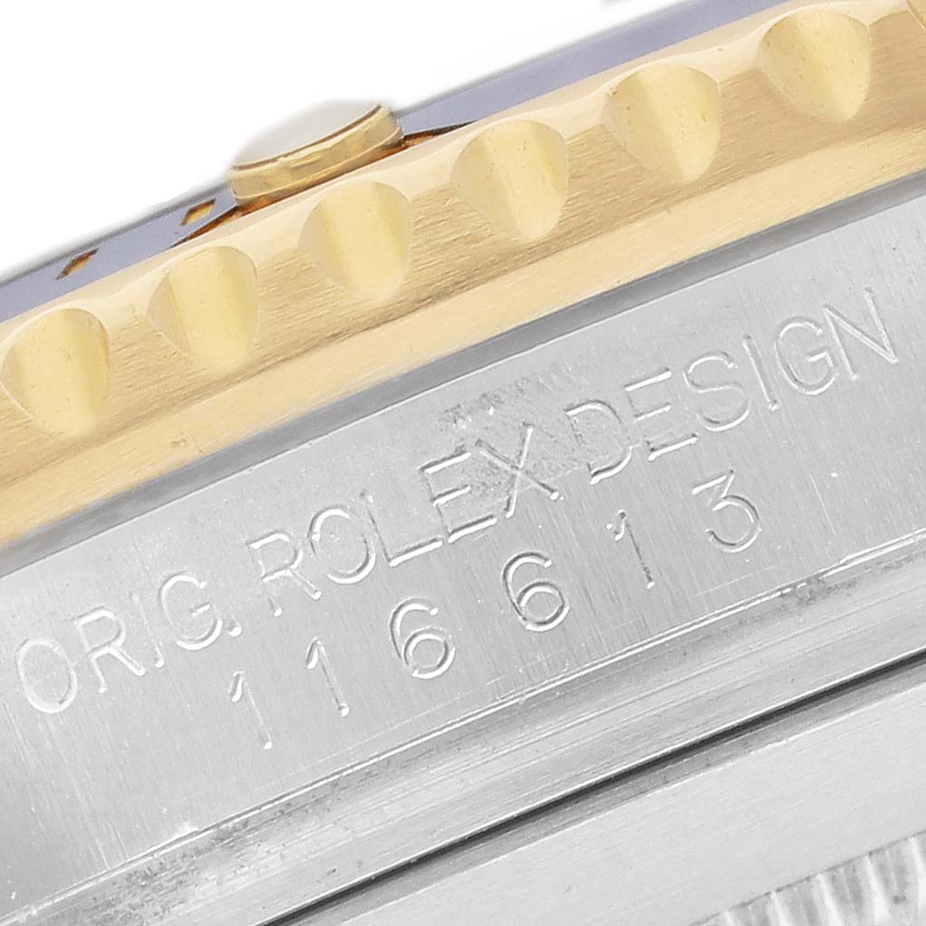 The image shows a close-up of the side of a Rolex Submariner 116613 Men's Steel and Gold (two tone) Blue Dial, highlighting the engraved model details and the edge of the bezel.
