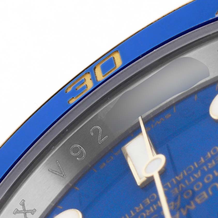 The image shows a close-up of the Rolex Submariner 116613 Men's Steel and Gold (two tone) Blue Dial's bezel with the "30" marking and part of the blue dial with indices.