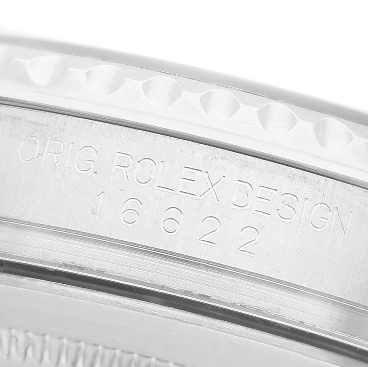 The image shows a close-up of the engraved casing with design numbers on a Yacht-Master model by Rolex.