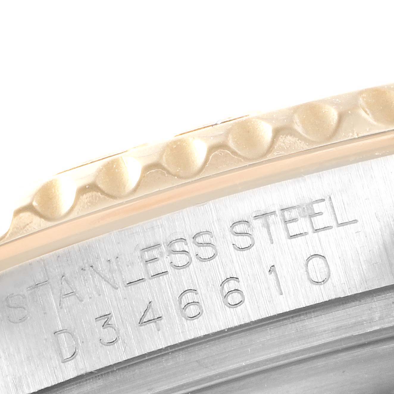 This image shows a close-up of the edge of the bezel and part of the case's serial number on a Rolex Yacht-Master 16623 Men's Steel and Gold (two tone) White Dial 16623 Men's Steel and Gold (two tone) White Dial watch.