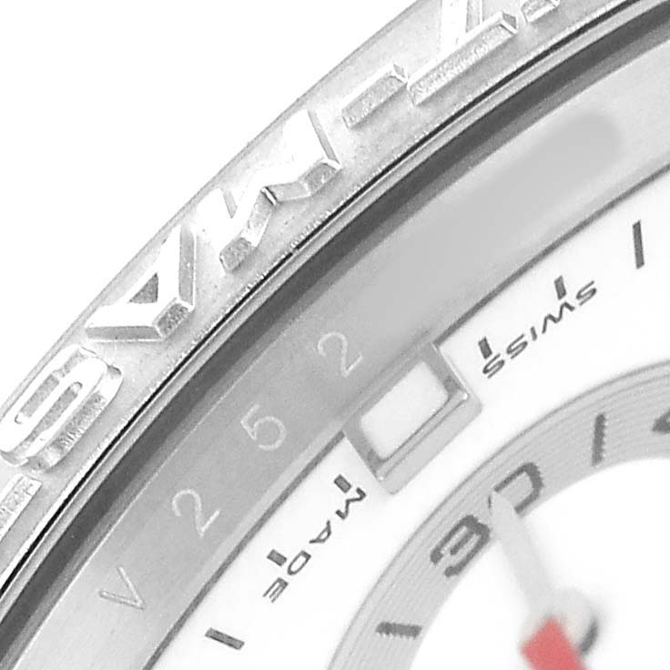 The image shows a close-up of the bezel and part of the dial of a Rolex Yacht-Master 116689 Men's White Gold White Dial, highlighting the "SWISS MADE" detail.