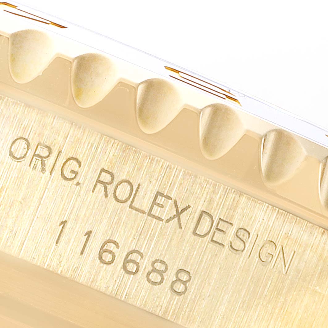 This close-up image shows the edge of a bezel and the engraved serial number on the case of a Rolex Yacht-Master 116688 Men's Yellow Gold White Dial 116688 Men's Yellow Gold White Dial watch.