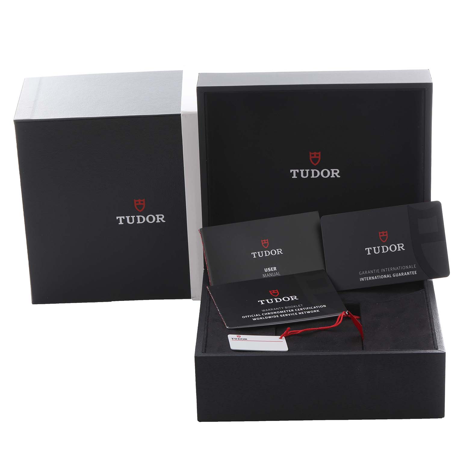 The image shows the packaging and accessories for a Tudor Heritage Black Bay 79030N Men's Stainless Steel Black Dial 79030N Men's Stainless Steel Black Dial watch, including a box, manual, and guarantee card.