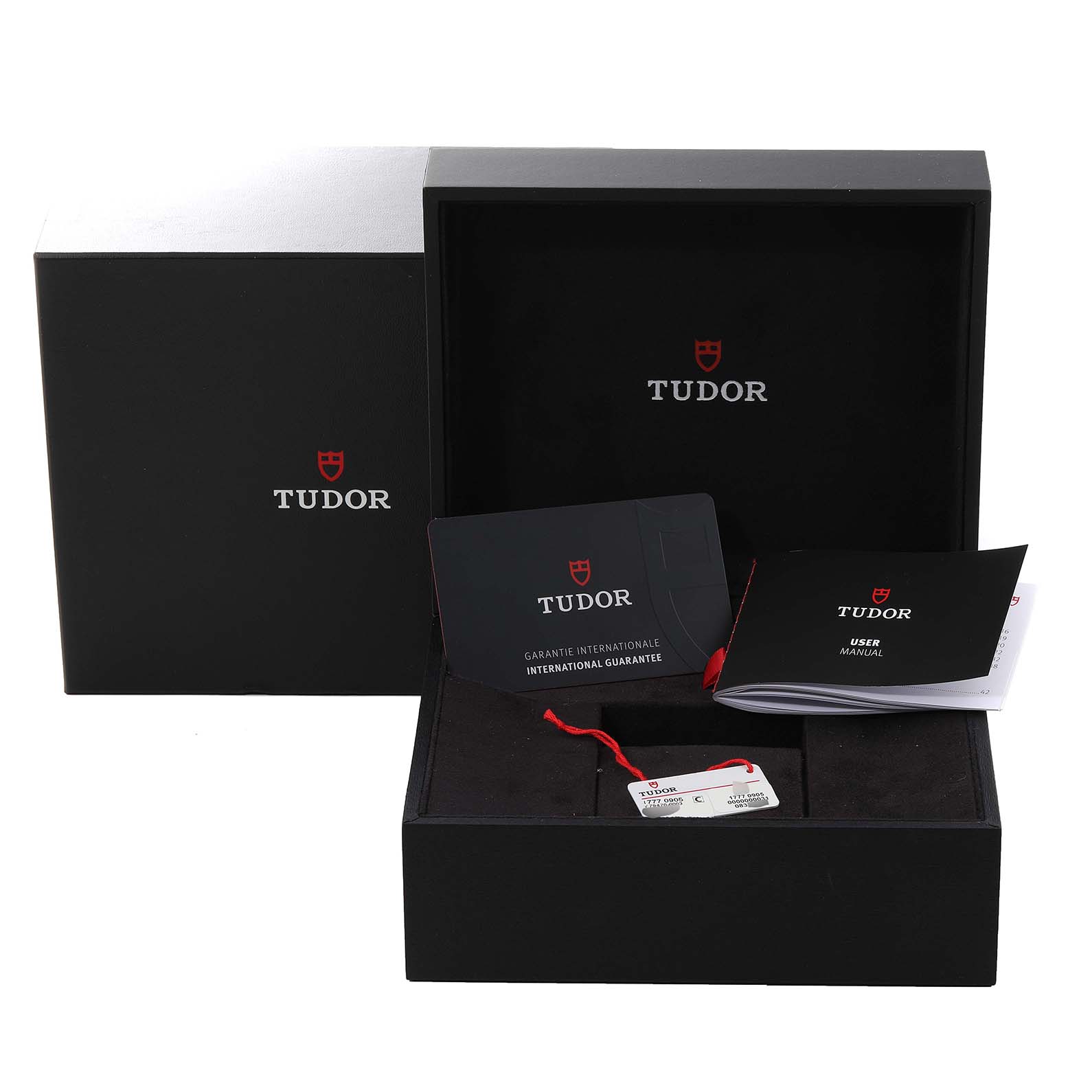 The image shows an open Tudor Heritage Black Bay M79470-0003 Men
s Stainless Steel Black Dial M79470-0003 Men
s Stainless Steel Black Dial watch box with international guarantee cards and a user manual.