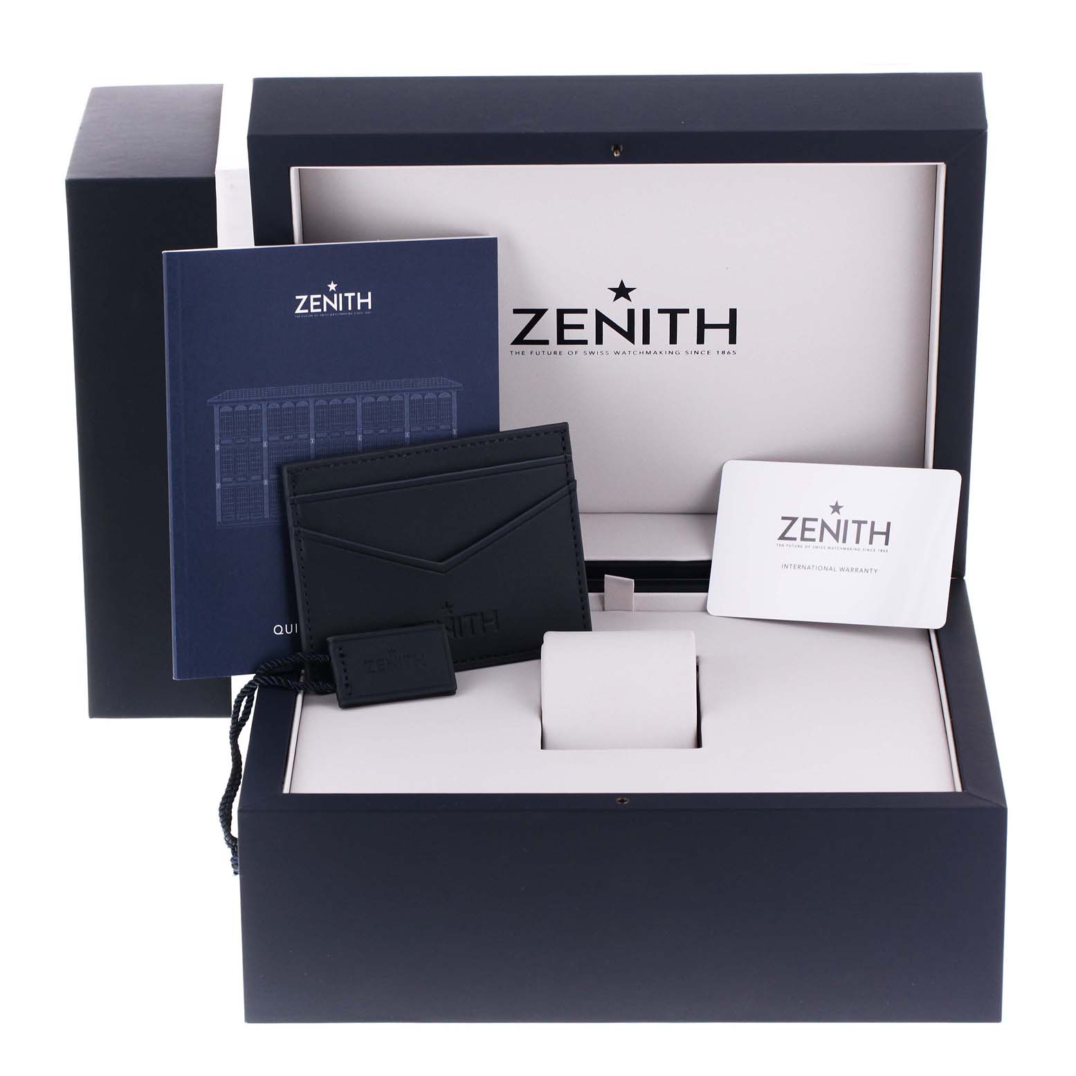 The image shows accessories for the Zenith Chronomaster 03.3100.3600 Men
s Stainless Steel White Dial 03.3100.3600 Men
s Stainless Steel White Dial model, including a warranty card, manual, wallet, and box.