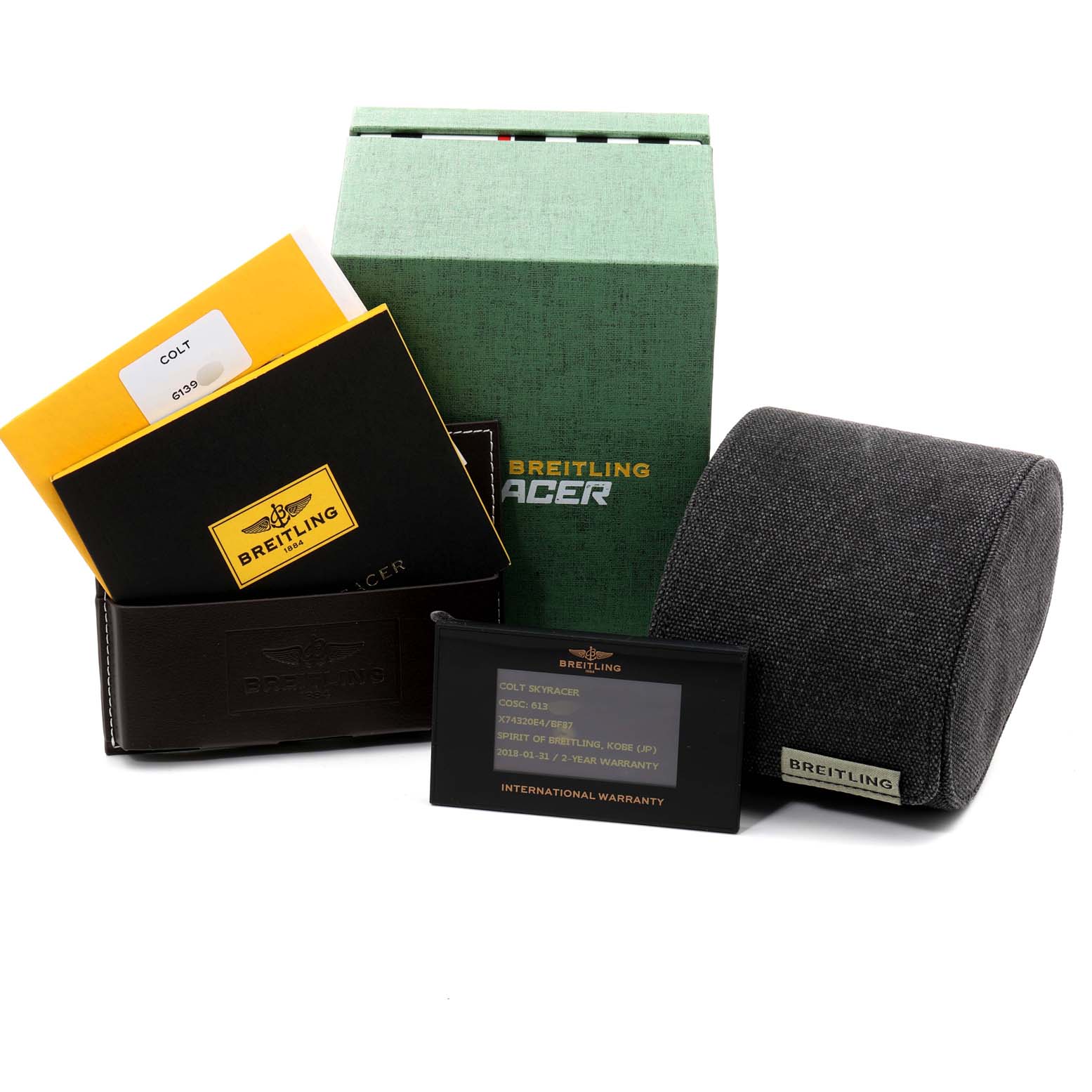 The image shows the accessories of the Breitling Colt X74320 Men's Titanium Black Dial X74320 Men's Titanium Black Dial watch, including a box, manuals, warranty card, and a watch cushion.